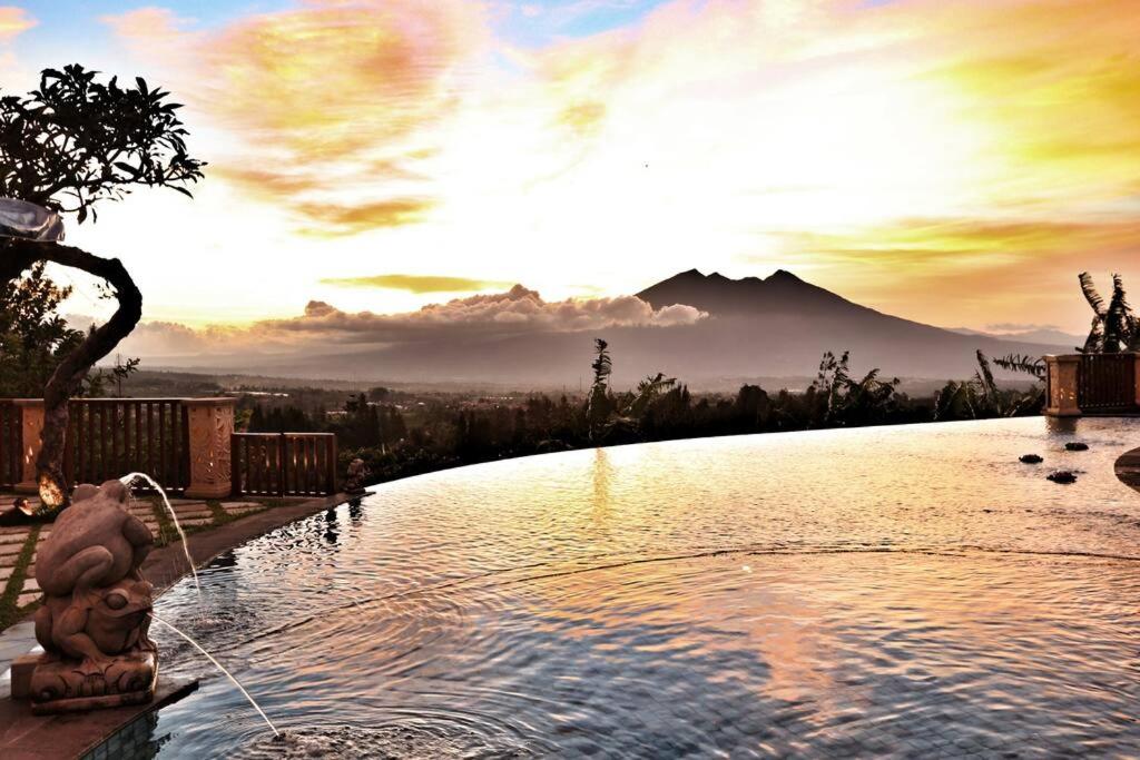 a swimming pool with a view of a mountain at PURI BALI STANIA, Cisarua West Java in Cilama