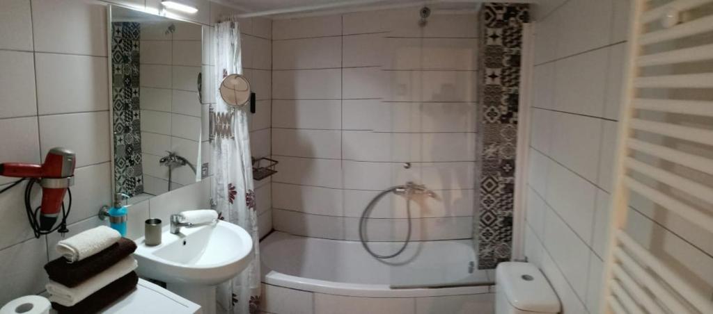 a bathroom with a tub and a sink and a toilet at Apartment by the beach with amazing sea view in Perea