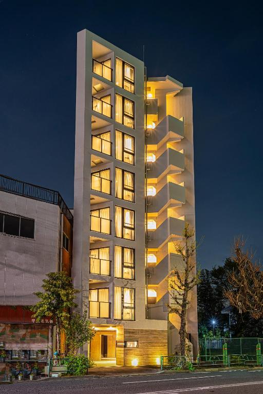 a tall building with many windows at night at Zaito Tokyo East Mukojima APT in Tokyo