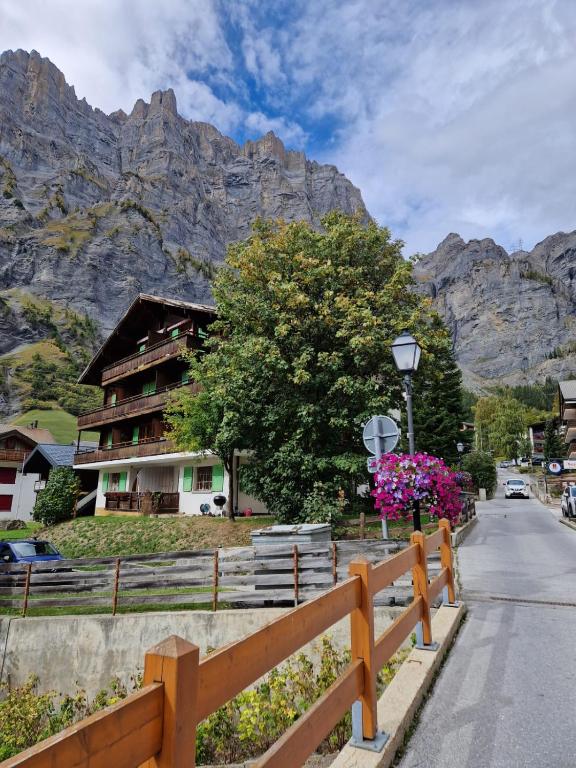 a wooden fence on the side of a road with a mountain at Studio Luizet Nr 28 in Leukerbad
