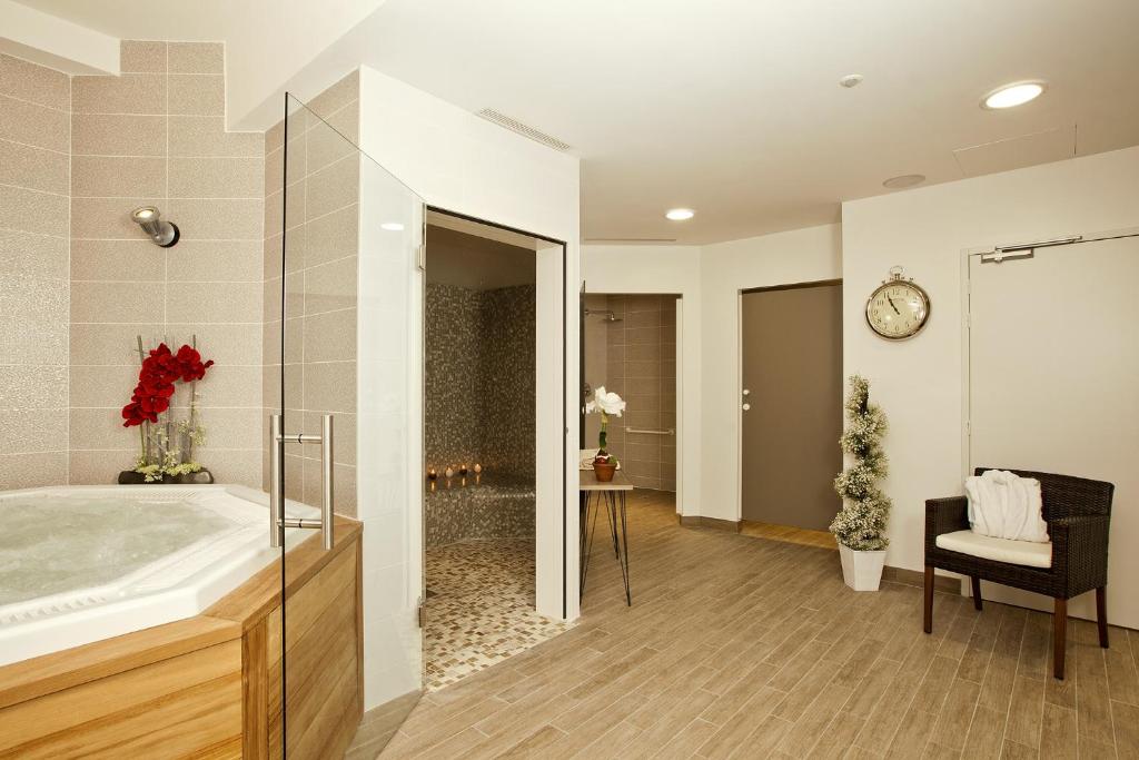 a bathroom with a large sink and a mirror at Residhome Arcachon Plazza in Arcachon