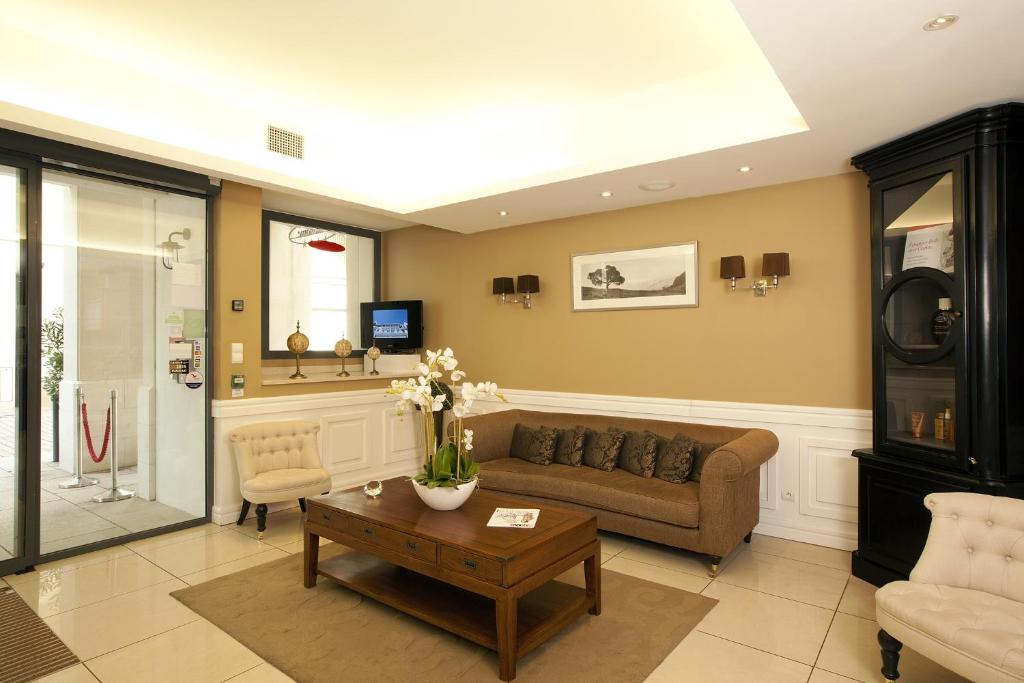 a living room with a couch and a table at Residhome Arcachon Plazza in Arcachon