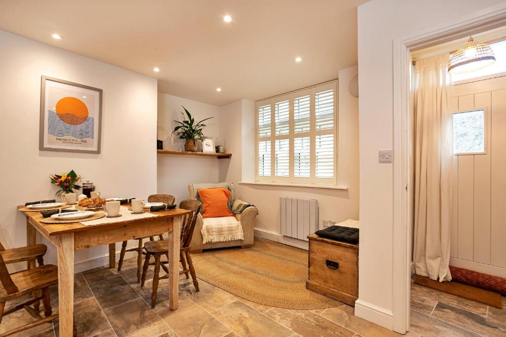 a living room with a table and a chair at Finest Retreats - Courtyard Cottage in Kendal