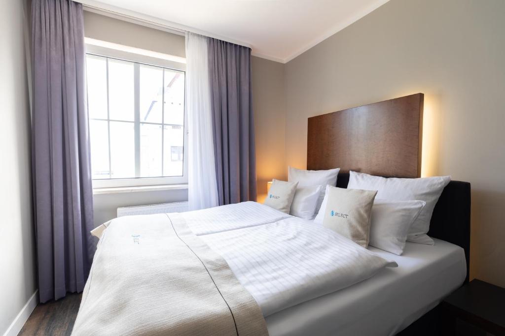 Postel nebo postele na pokoji v ubytování Select Hotel Friedrichshafen