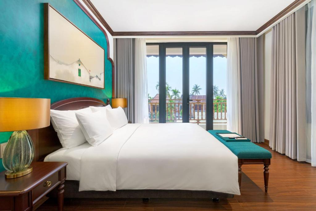 Postel nebo postele na pokoji v ubytování Anmira Resort & Spa Hoi An by The Unlimited Collection, Managed by the Ascott