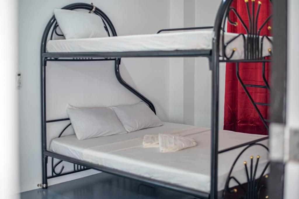 Postel nebo postele na pokoji v ubytování Dreamshore Ki'wi Beach Resort