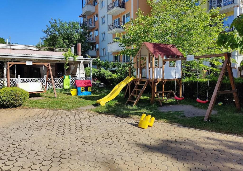 a playground with a slide and a play structure at Charis Cozy Family apart at Sun Village Complex close to the Beach in Sunny Beach