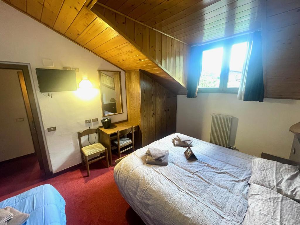 Postel nebo postele na pokoji v ubytování Hotel Biancaneve