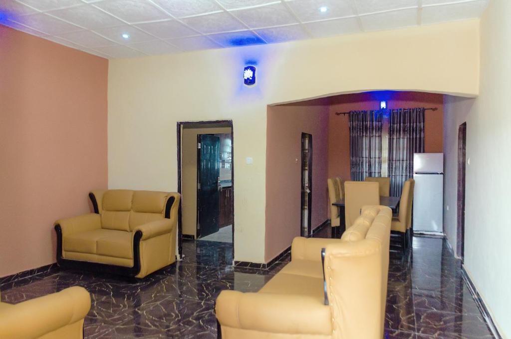 a waiting room with yellow chairs and a waiting room at Royal Guests Holiday Lets in Benin City