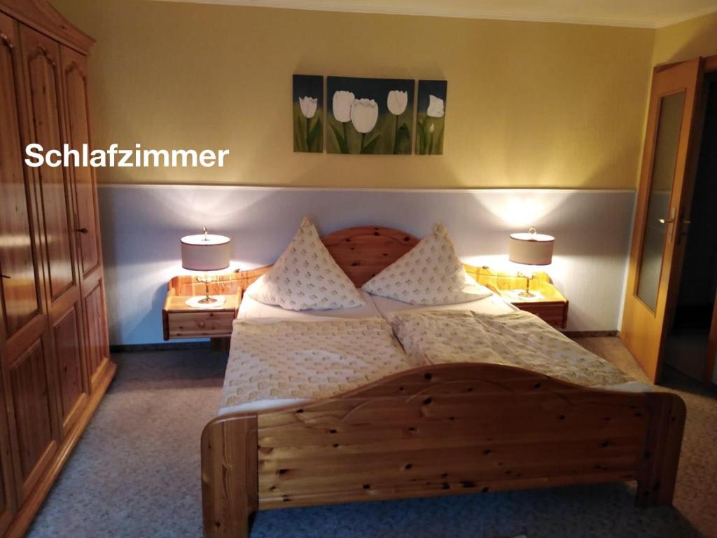 a bedroom with a wooden bed with pillows on it at Ferienwohnung Katharina I in Alf