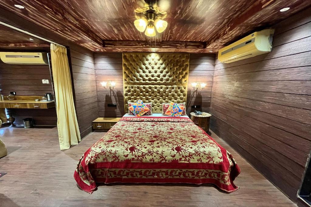 sypialnia z łóżkiem w drewnianej ścianie w obiekcie HOTEL SHAILLY INN w mieście Ahmadabad