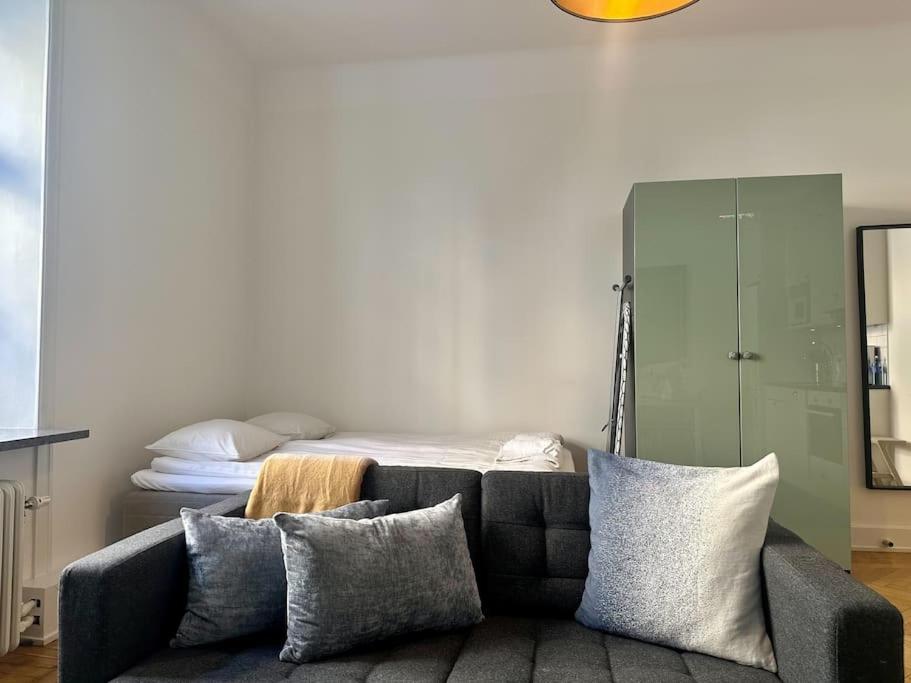 a living room with a couch and a bed at Stay Inn Luxury Apartments Ostermalm in Stockholm