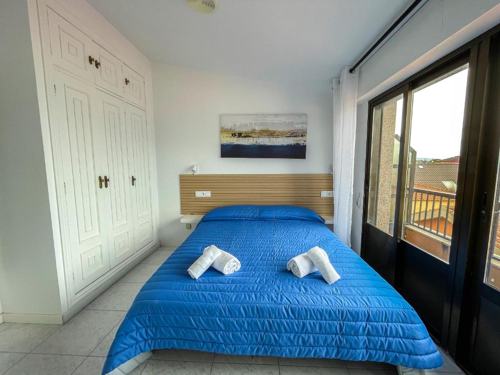 Cama o camas de una habitación en Complejo Tamanaco Illa de Arousa 3000