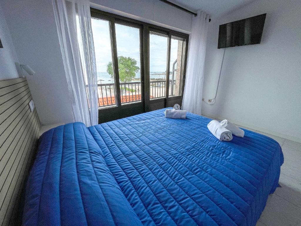 Cama o camas de una habitación en Complejo Tamanaco Illa de Arousa 3000