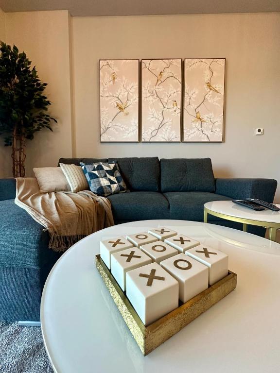 Hotel Yas Sea Views 1bhk Ferrari World & F1 Gym, a living room with a couch and a table at Yas Sea Views 1bhk Ferrari World & F1 Gym in Abu Dhabi