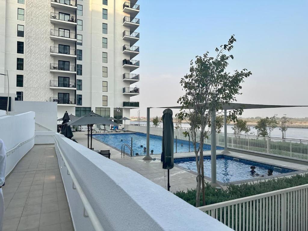 a swimming pool on the balcony of a building at Elegant 1br With Partial Canal View At Yas Island in Abu Dhabi