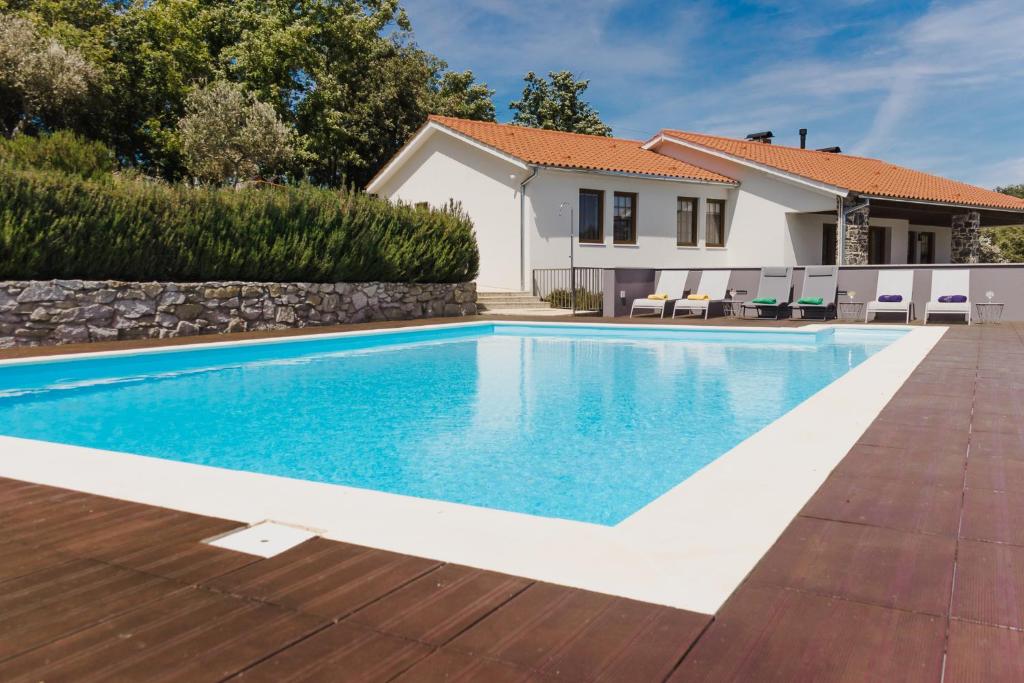 a swimming pool in the backyard of a house at Estrela de Montesinho in Bragança