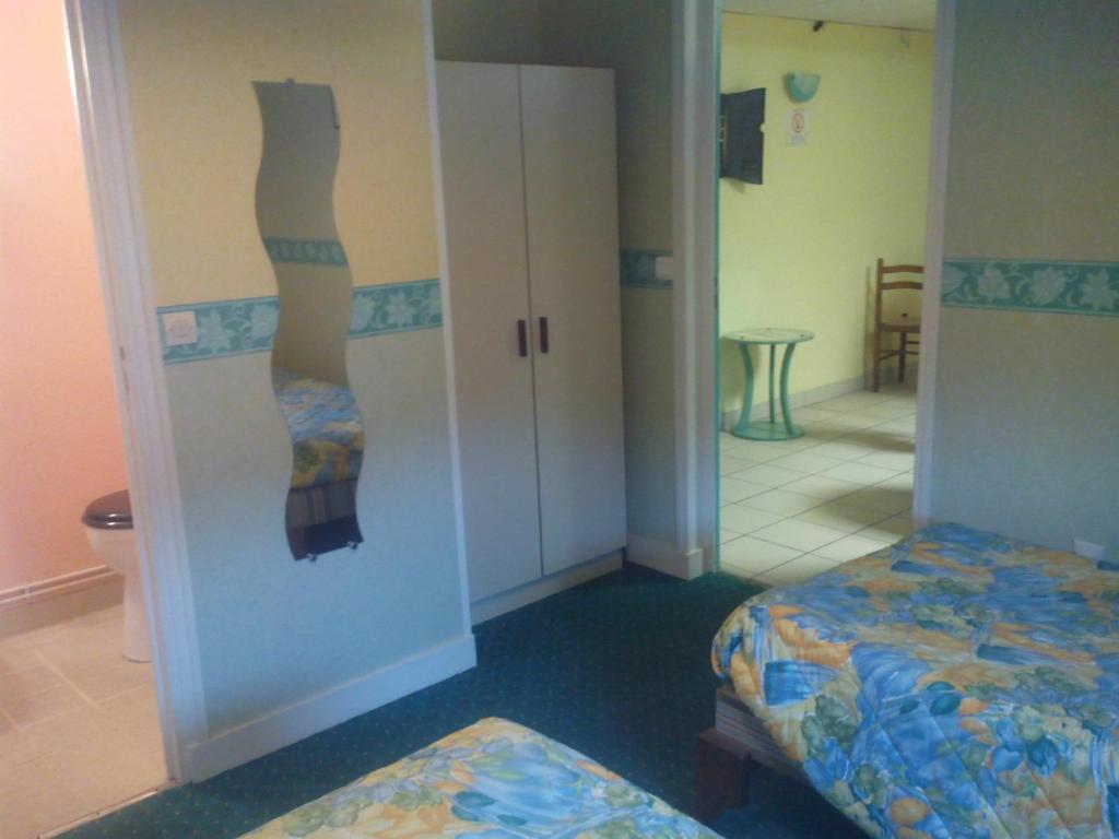 Postel nebo postele na pokoji v ubytování Hôtel l'Eden