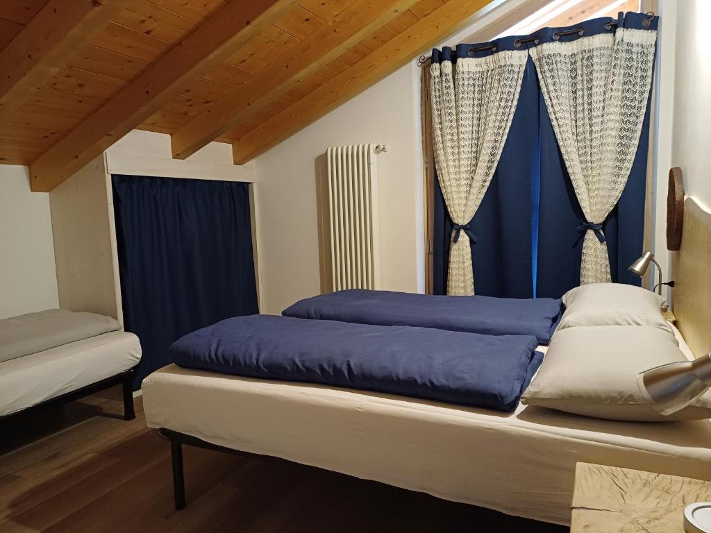 Postel nebo postele na pokoji v ubytování Casa Bresadola - Pellizzano