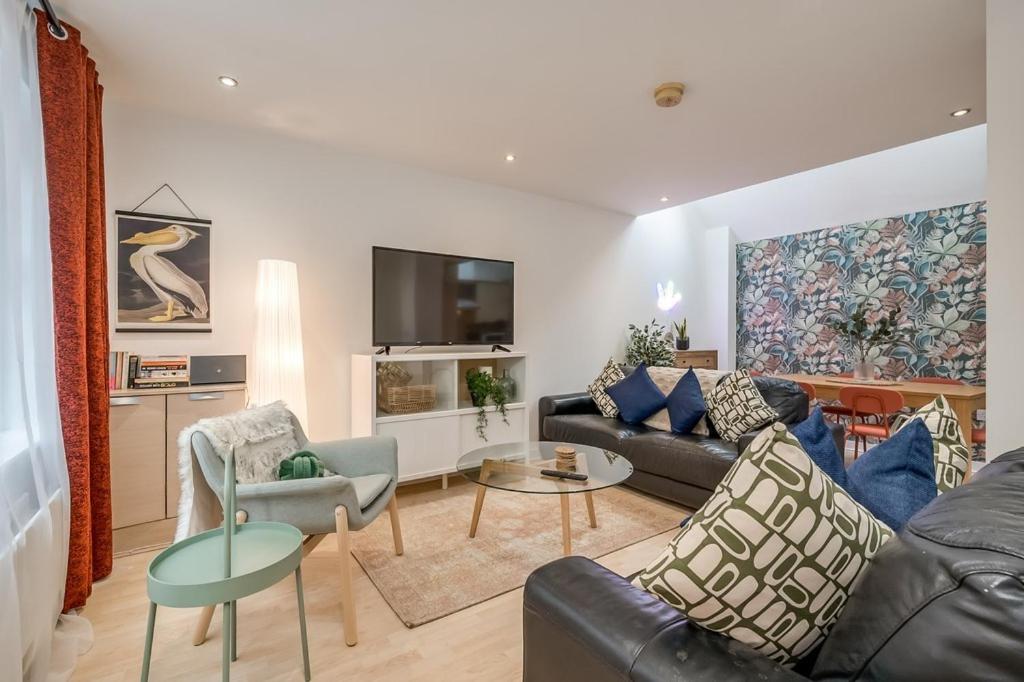 a living room with a couch and a table at Central Belfast Apartments Somerset Mews in Belfast