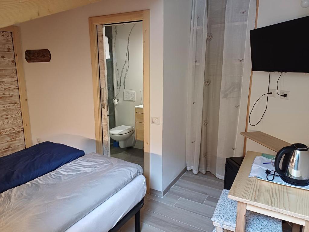 Postel nebo postele na pokoji v ubytování Casa Bresadola - Pellizzano