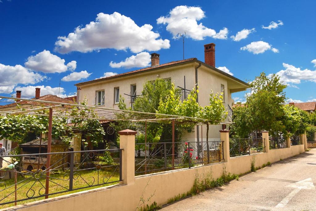 a white house with a fence in front of it at Apartment Davor 2330 in Pula