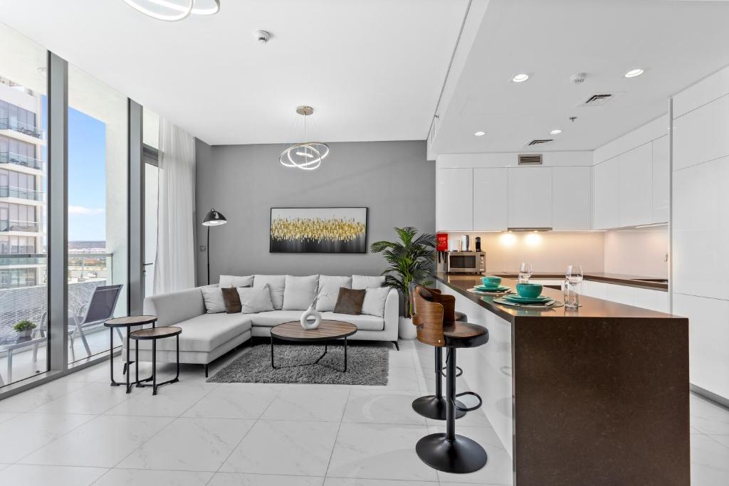 a living room with a couch and a table at Premium 1-BR with Exquisite Layout in District One in Dubai