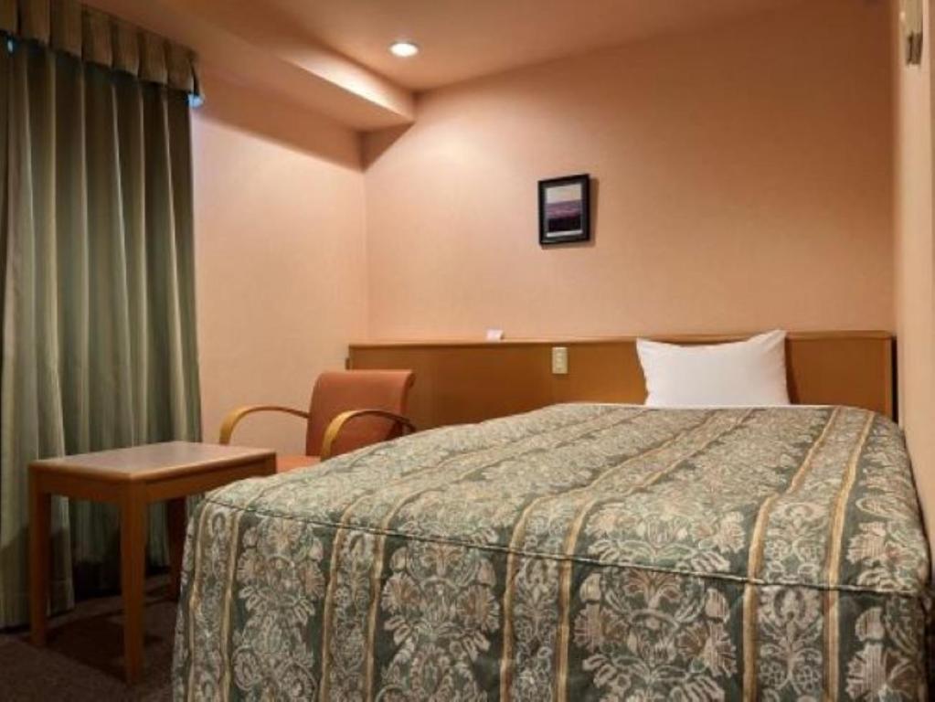 Кровать или кровати в номере Tabist Hirosaki Touei Hotel