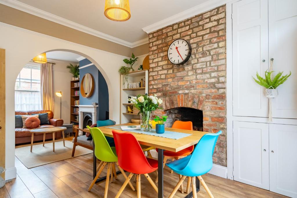 a living room with a table and colorful chairs at Buckingham Townhouse in York