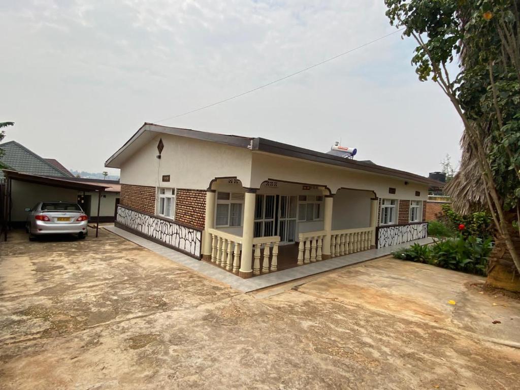 a house with a car parked in front of it at BIZI HOMES in Kigali