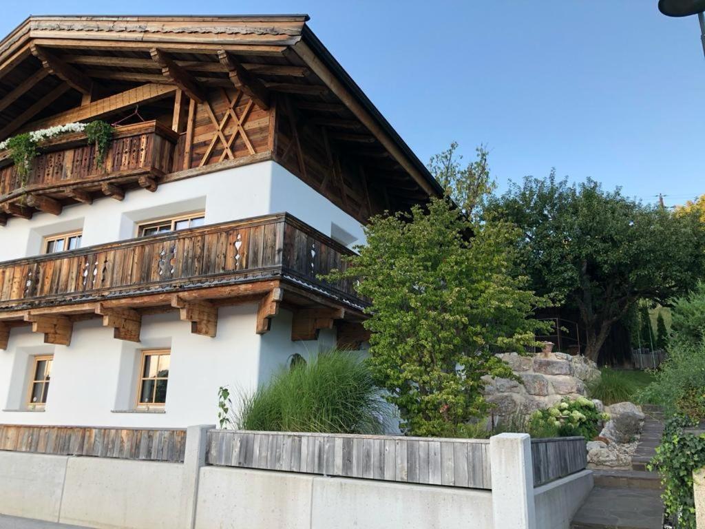 a house with a wooden balcony on the side of it at Haus Ehammer in Hopfgarten im Brixental