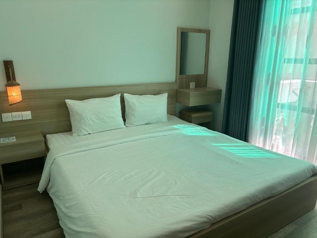 Giường trong phòng chung tại Green Inn Phu Quoc Hotel