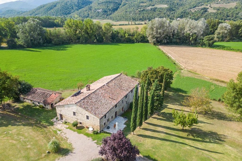 an aerial view of an old house in a field at Villa di John in Umbertide