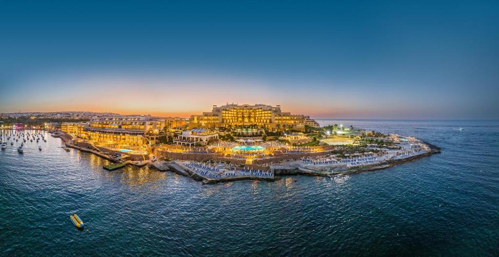an aerial view of a resort on the ocean at Corinthia St George's Bay in St. Julianʼs