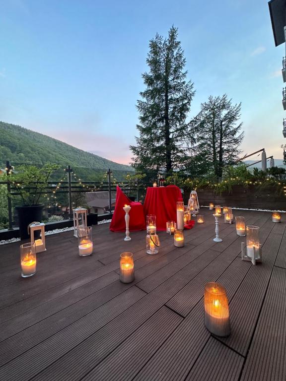 a table with candles and lights on a deck at Reef Terrace Apartments in Yaremche