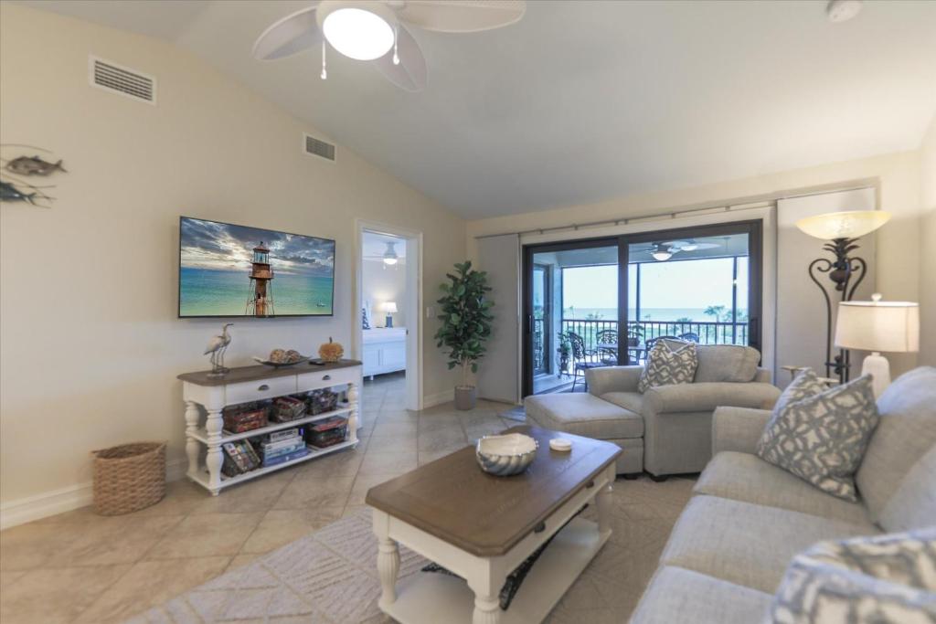 a living room with a couch and a table at SANDPIPER BEACH 205 in Sanibel