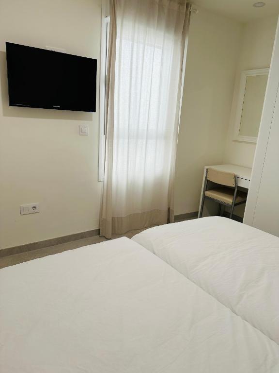 TV a/nebo společenská místnost v ubytování Apartamentos Turísticos Victoria