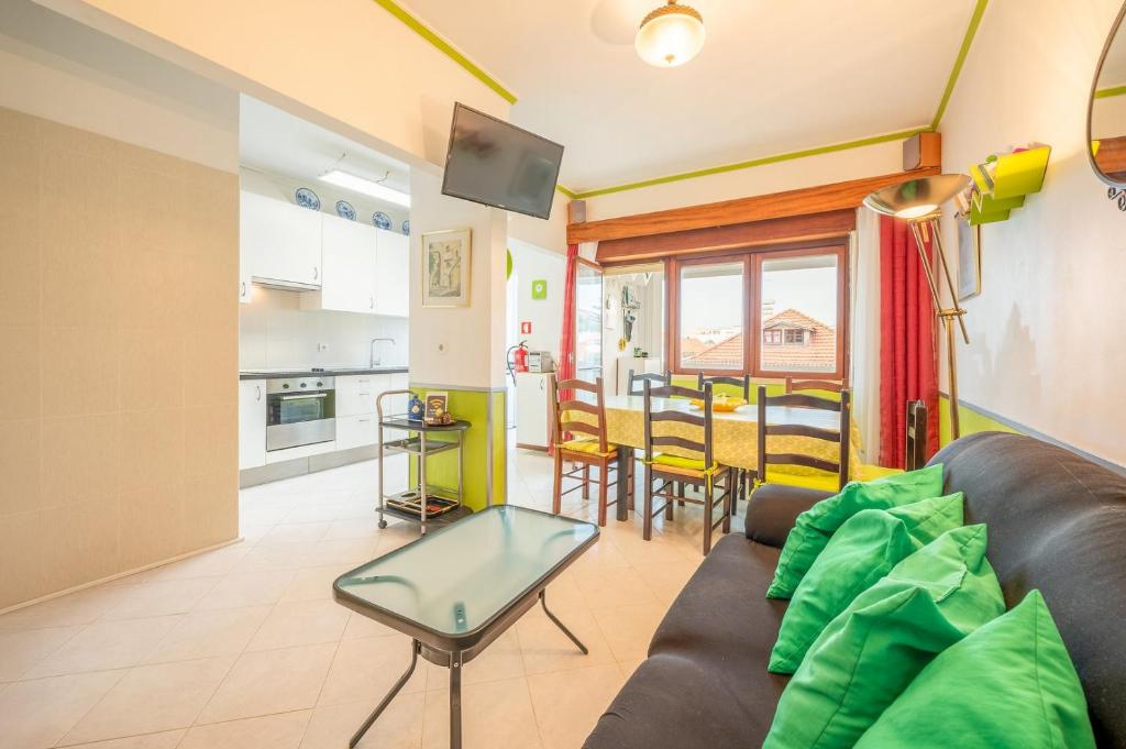 a living room with a couch and a table at GuestReady - Sea Breeze in Costa da Caparica in Lisbon