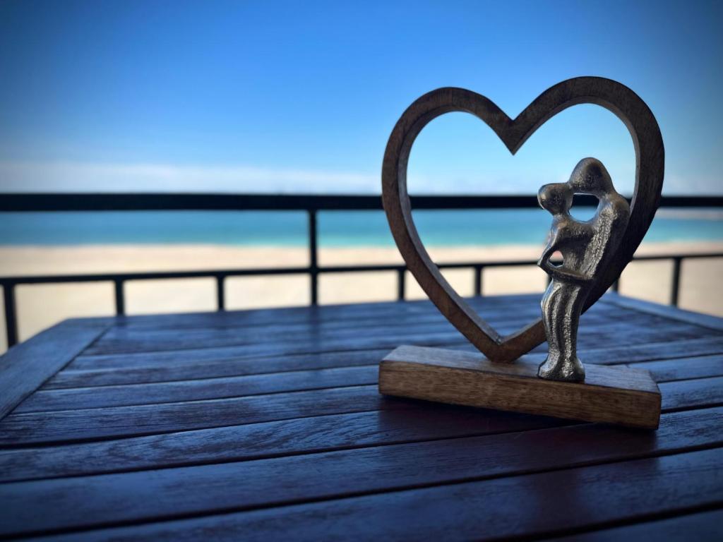 a heart statue sitting on top of a boardwalk at VILA FLORIDA & MIAMI in Eforie Nord