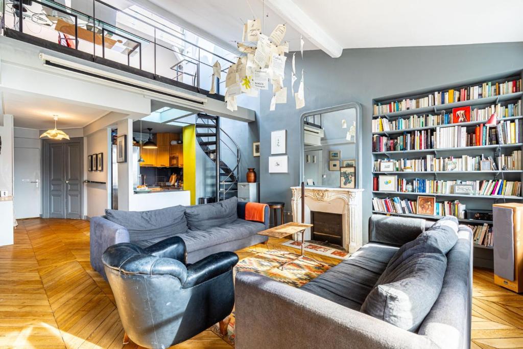 un salon avec deux canapés et une cheminée dans l'établissement GuestReady - Parisian Charm near Sacré-Cœur, à Paris