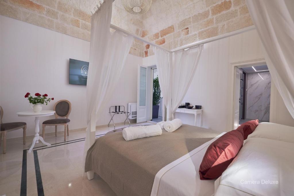 a bedroom with a bed and a table and a window at Volte D'Anima in Monopoli
