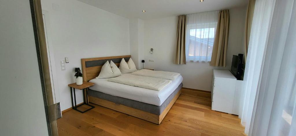 a bedroom with a bed and a television in it at Villa Juwel in Altenmarkt im Pongau