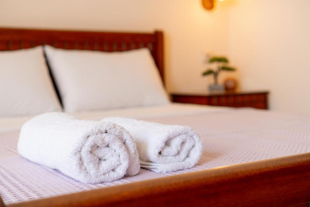 a pair of towels sitting on top of a bed at Apartment’s Vasileiou Suite 1 in Preveza