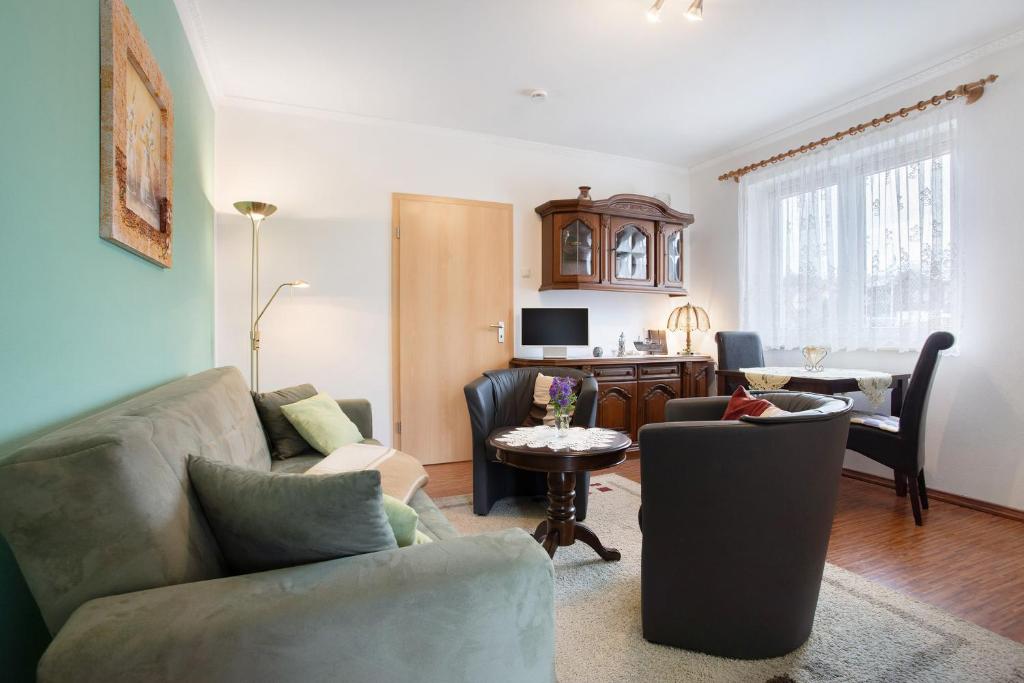 a living room with a couch and a table at Günther - Ferienwohnungen Zinnowitz in Zinnowitz