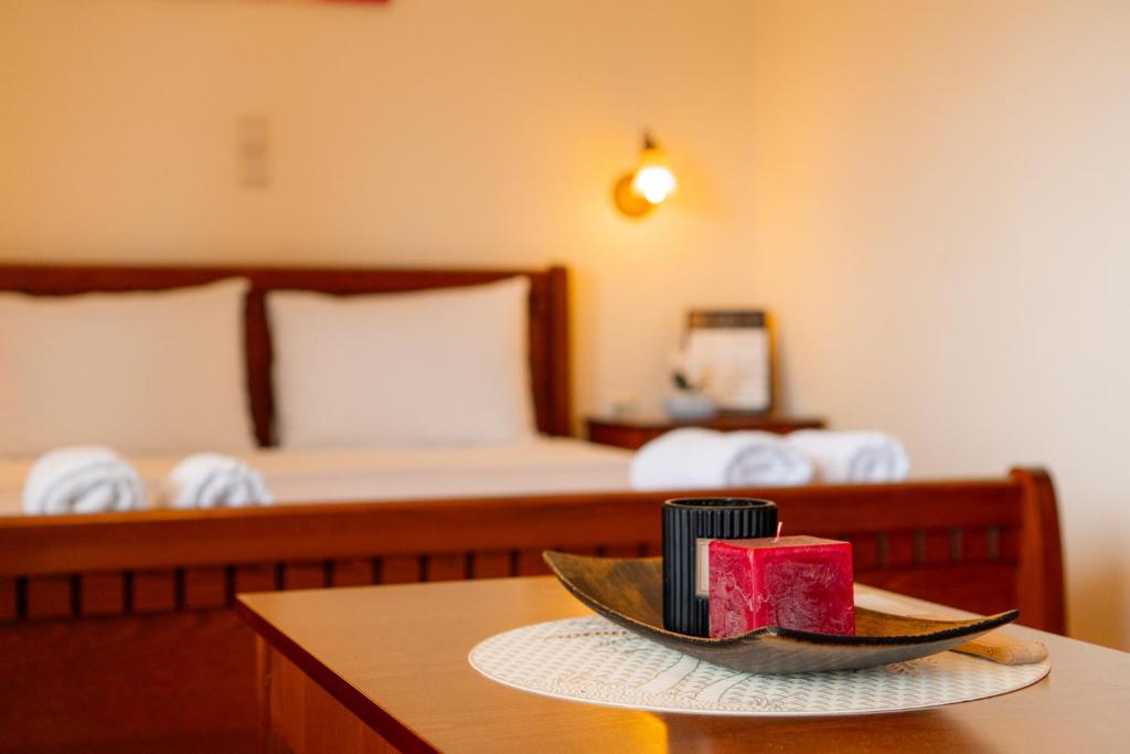 a room with a bed and a bowl of watermelon at Apartments Vasileiou Suite 4 in Preveza