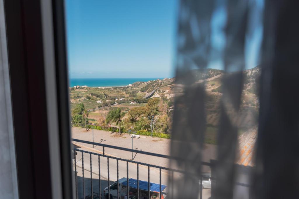 a view of a beach from a window at Casa Vacanza Merguli d'Oro in Siculiana