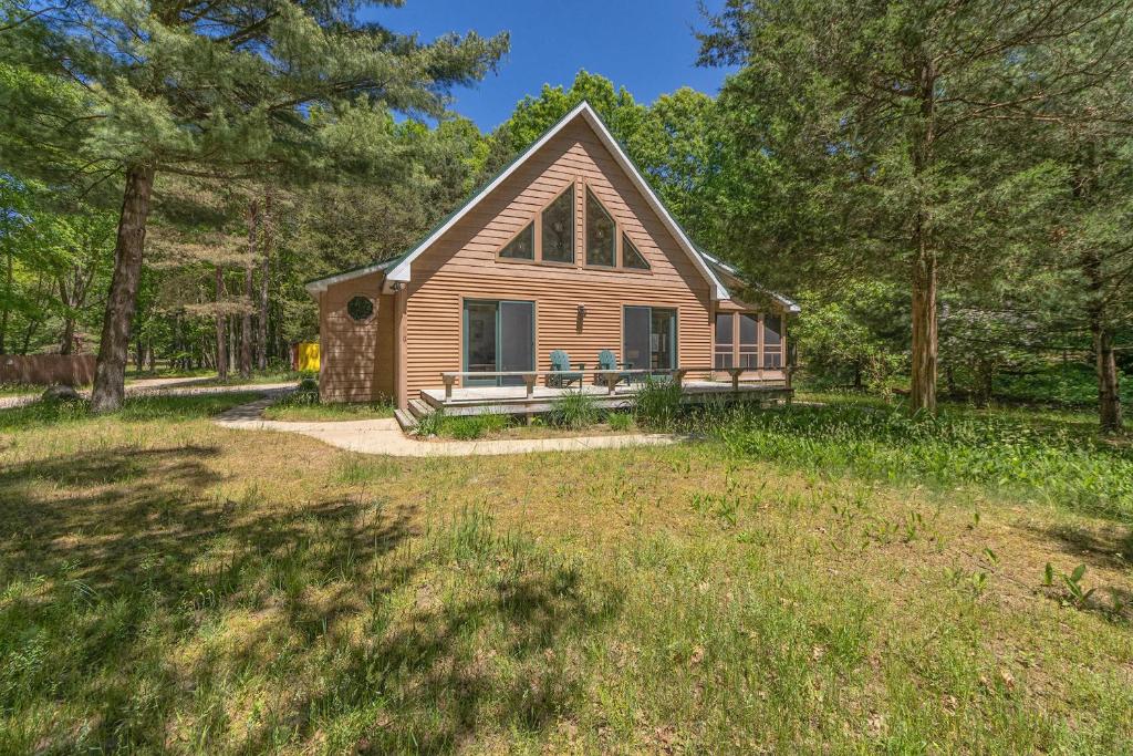 a small house in the middle of a yard at Nature lovers delight, private hot tub and a short walk to Lake MI in Fennville