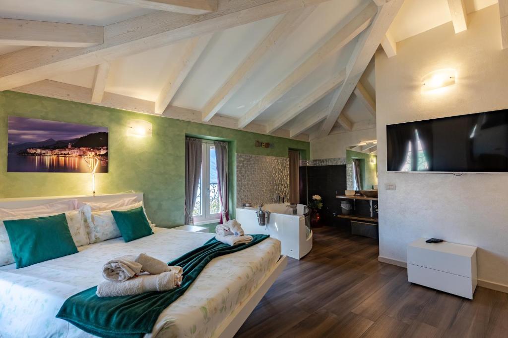 a bedroom with a large bed with two dolls on it at Villa Vitali - Bellagio in Bellagio