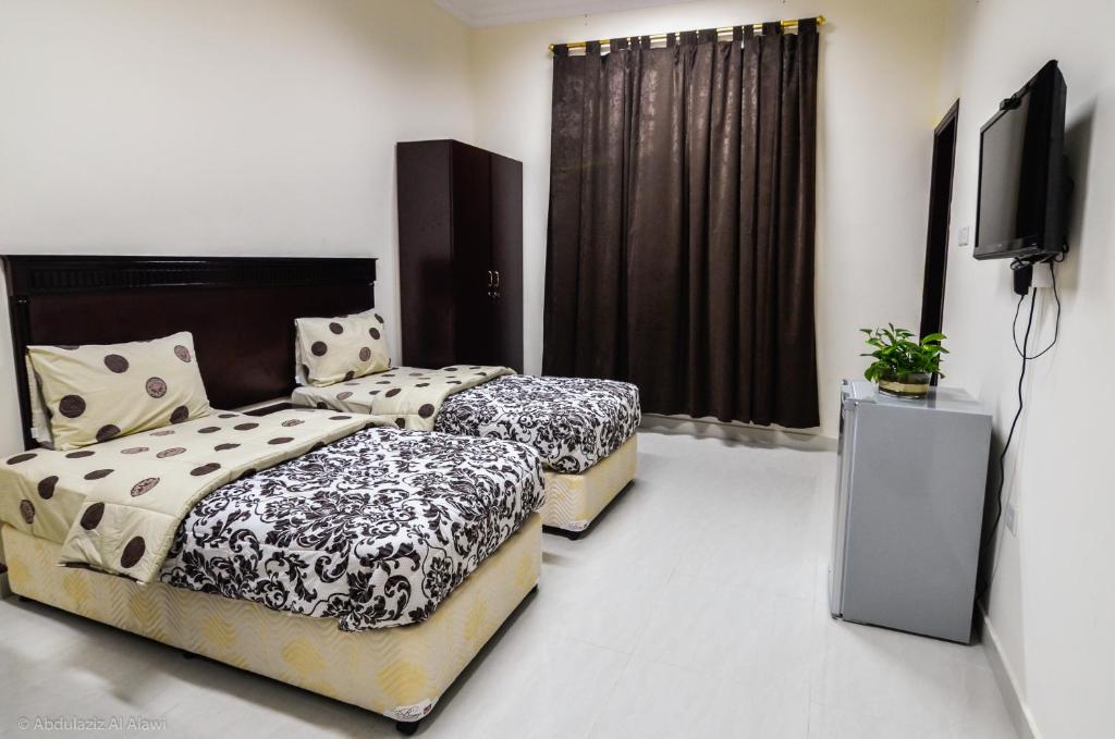 Postel nebo postele na pokoji v ubytování Al Jumhour Hotel Apartments