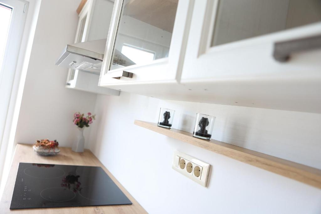 a kitchen with white cabinets and a sink at APART HOTEL ASTERIA in Ljubljana